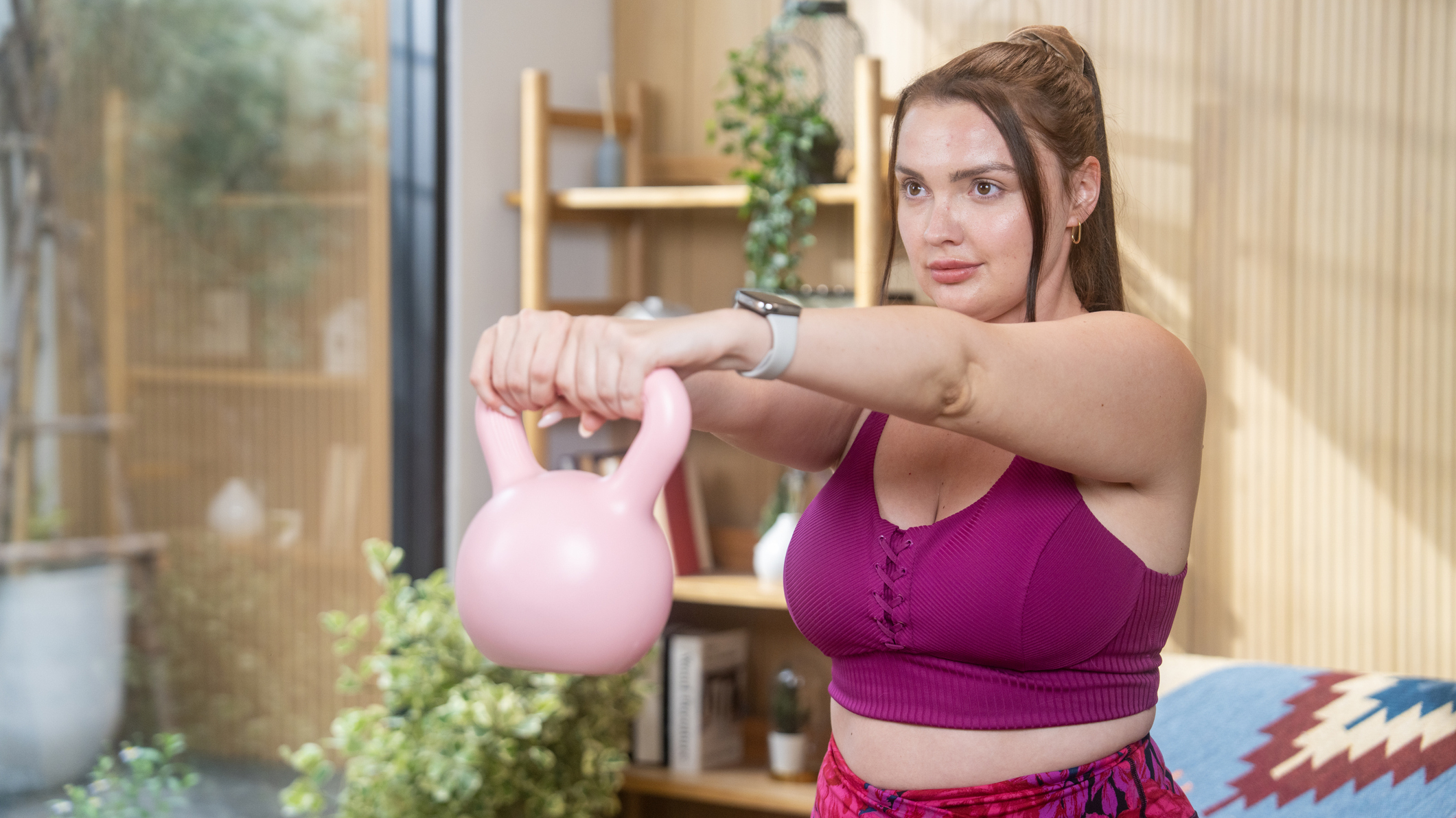 Woman exercising with kettlebell at home
