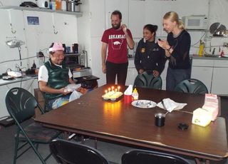 Members of the Mars 160 crew celebrate the birthday of Yusuke Murakami inside the FMARS hab.