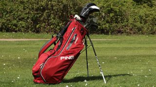 A red Ping hoofer golf bag pictured on the golf course