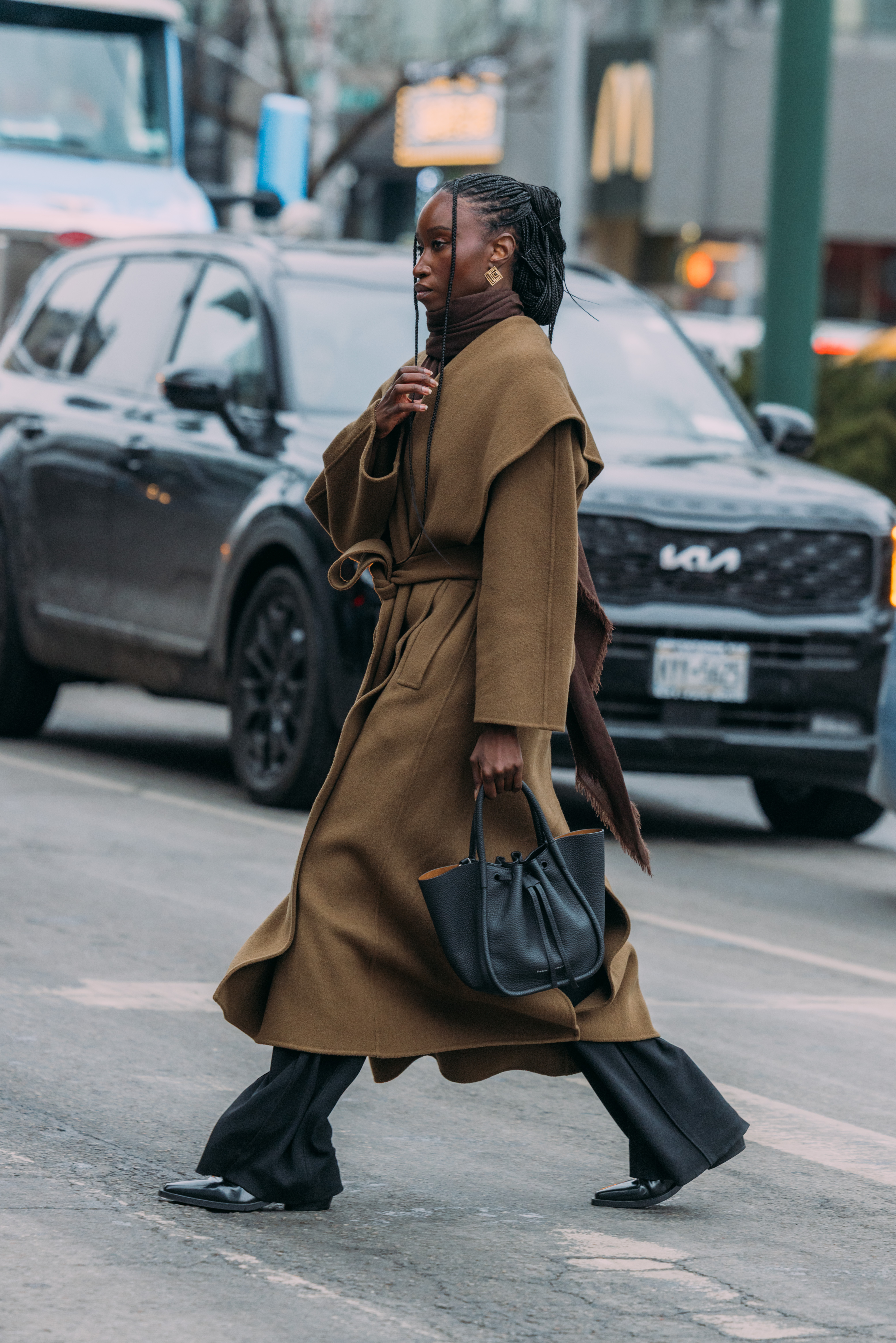 A woman wears black trousers during new york fashion week.