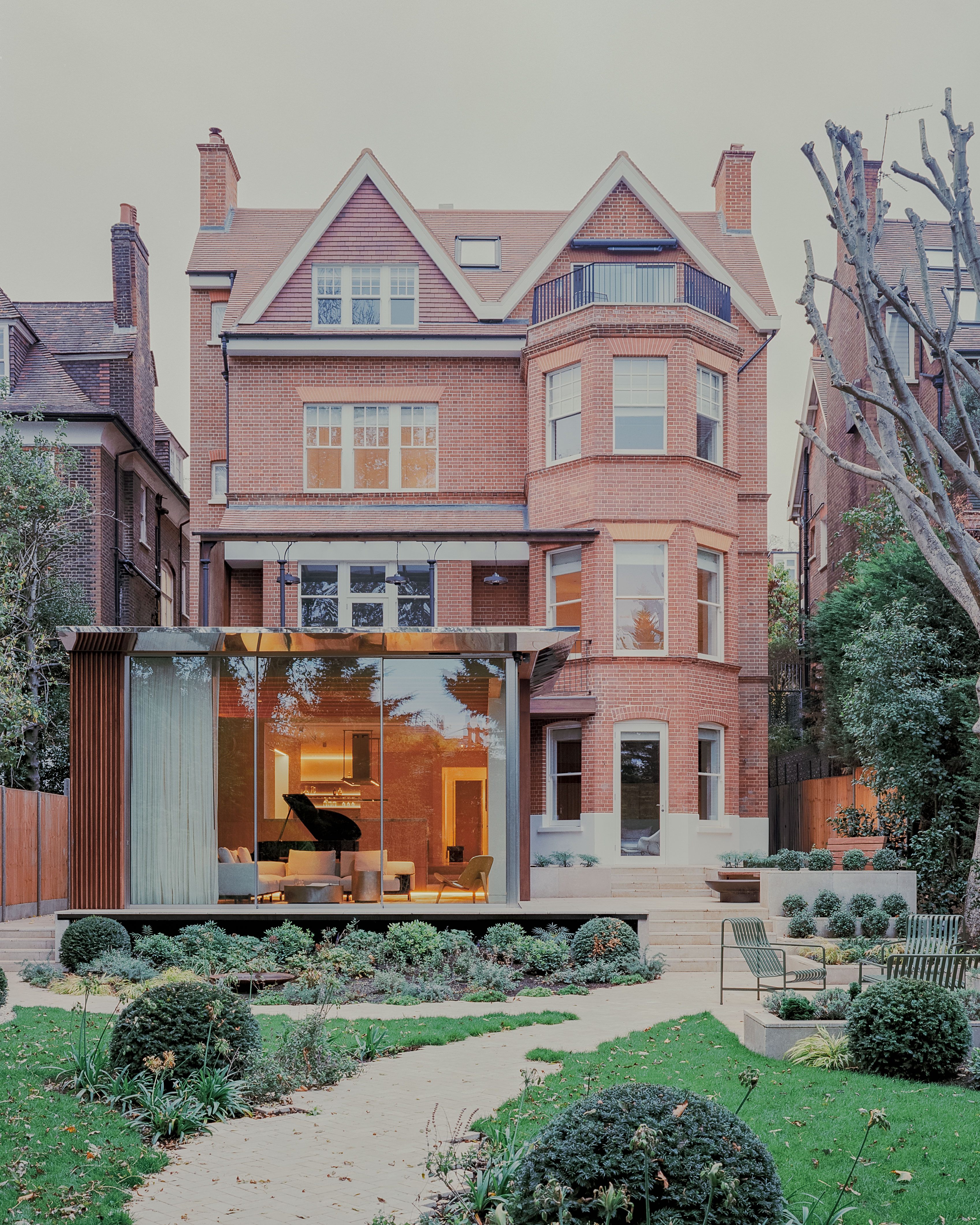 views of Panoramic House by Mata with a timber clad extension and built in furniture