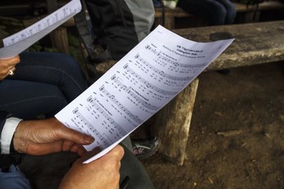 A person holds sheet music.