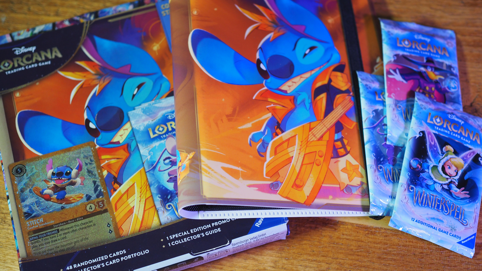 Collection Starter Set - Stitch Edition box, cards, boosters, and binder on a wooden surface