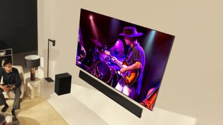 LG G4 OLED TV on beige wall with band on screen lifestyle image 