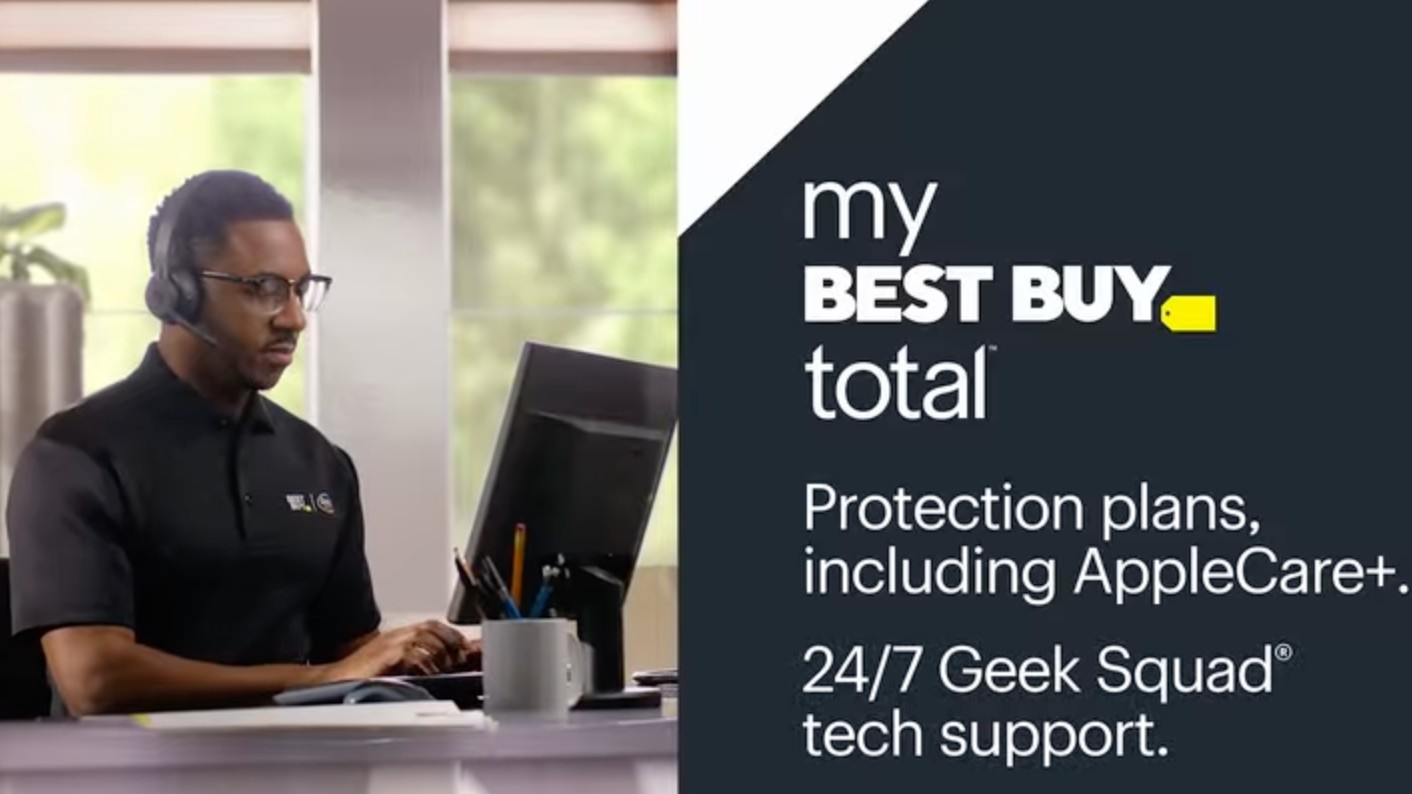 A promotional graphic for My Best Buy Total features the membership&#039;s benefits on a dark gray background next to an image of a Geek Squad agent wearing a headset and working at a computer.