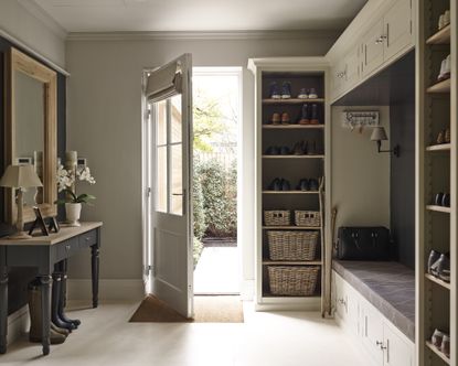 A mudroom with floor-to-ceiling storage and a boot bench with overhead cupboards