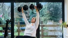 Woman holding dumbbells overhead