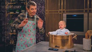 Rowan Atkinson as Trevor has a smiling baby in a pot on Man Vs. Baby.