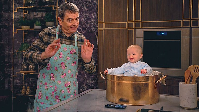 Rowan Atkinson as Trevor has a smiling baby in a pot on Man Vs. Baby.