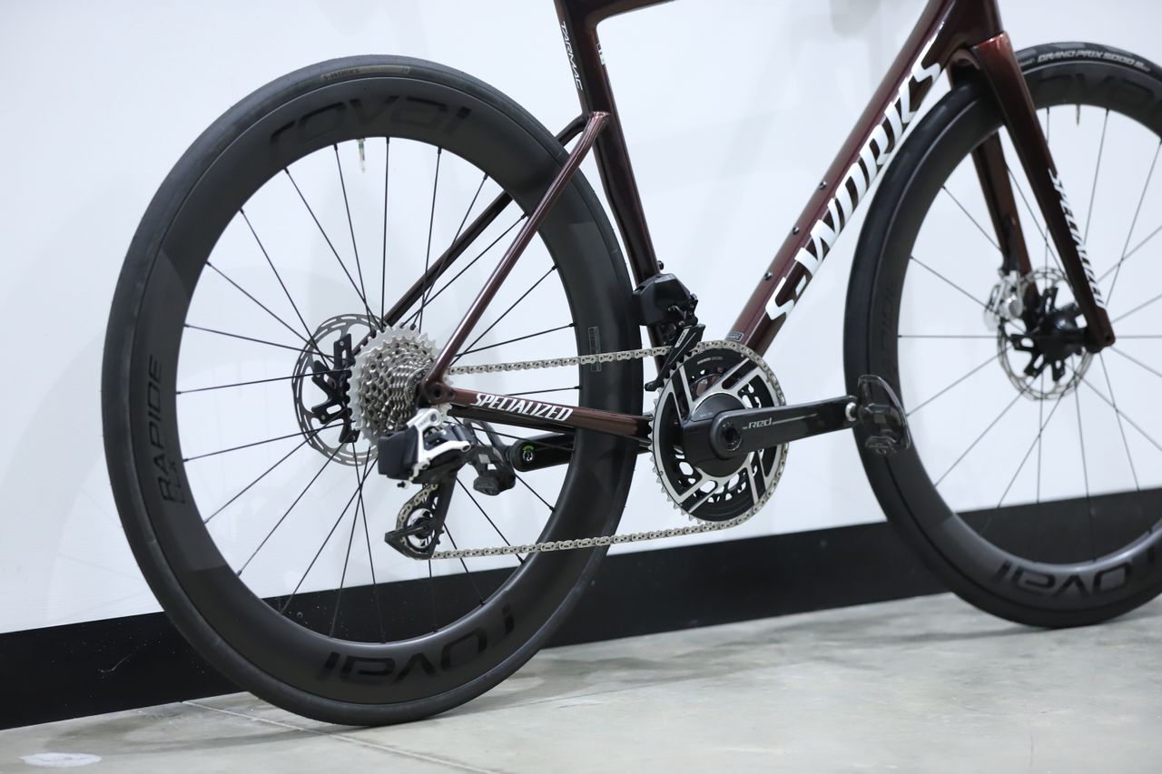 A red S-Works Tarmac SL8 stands against a white wall
