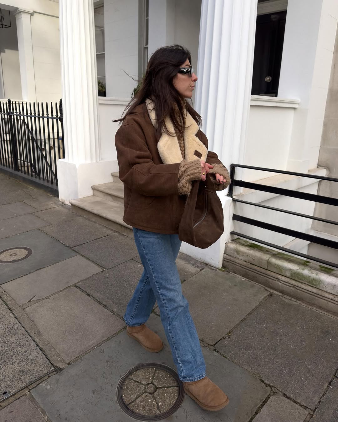 Influencer Francesca Saffari wearing straight-leg jeans and shearling-lined boots.