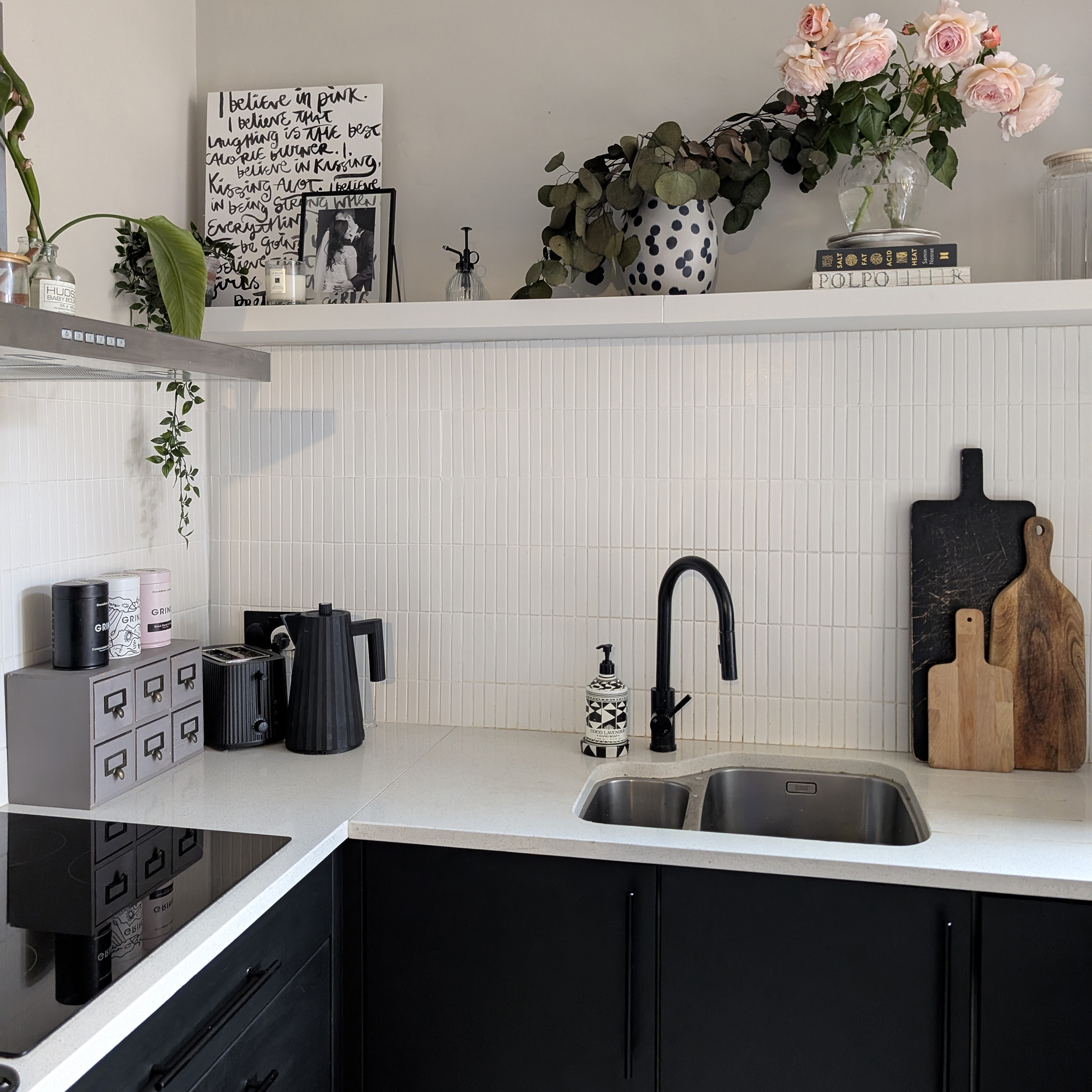 monochrome kitchen with flowers on an open shelf