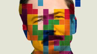 Taron Egerton as Henk Rogers, with colored blocks in front of him, in the Tetris poster.