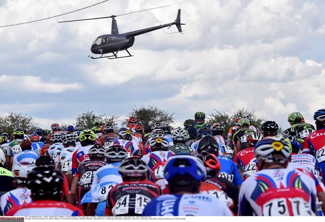 TV helicopter swoops down over the peloton during stage 7