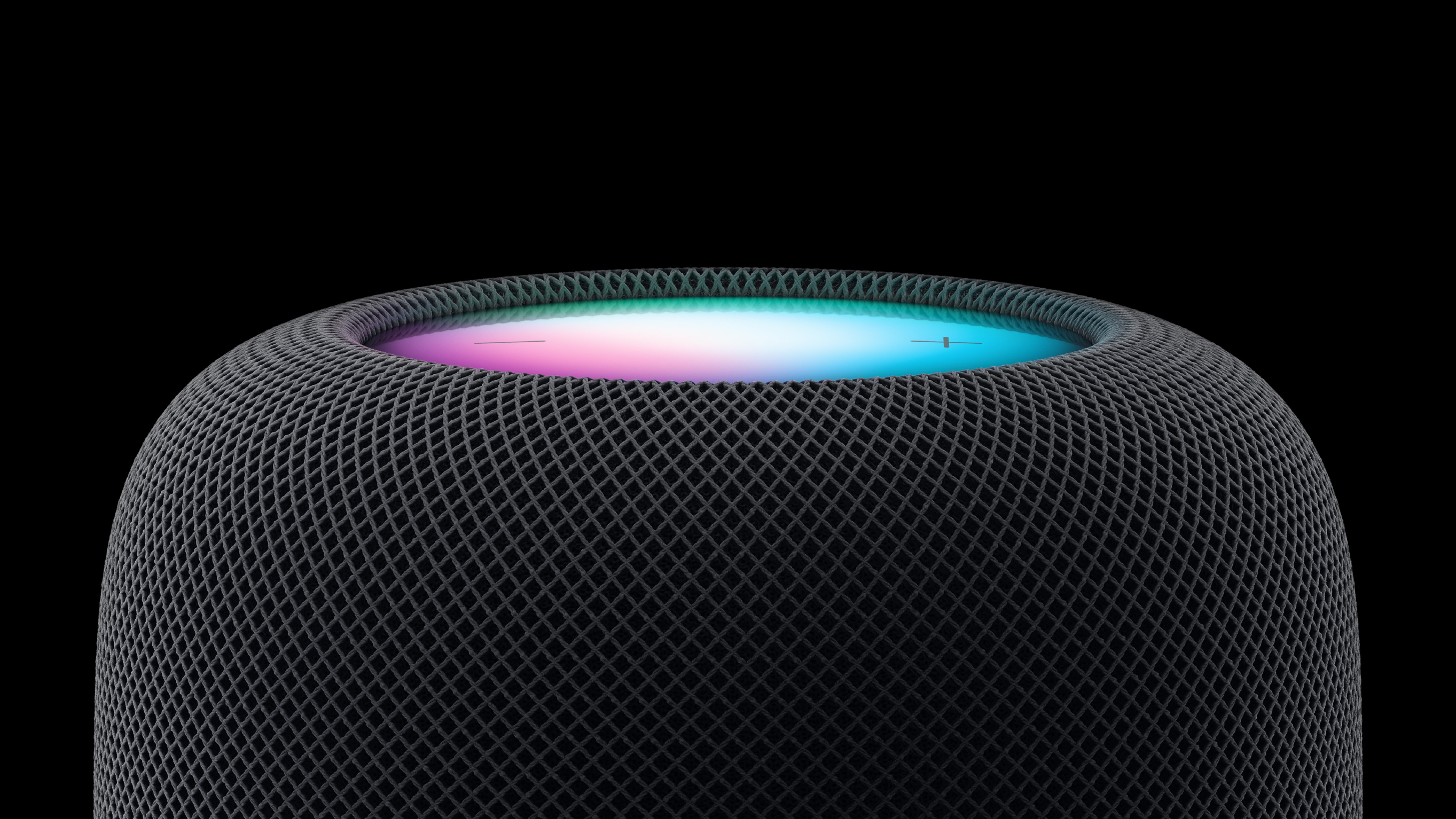 The Apple HomePod speaker on a black background
