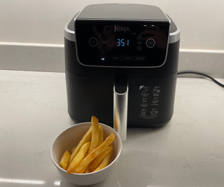 Ninja Air Fryer Pro next to a bowl of French fries