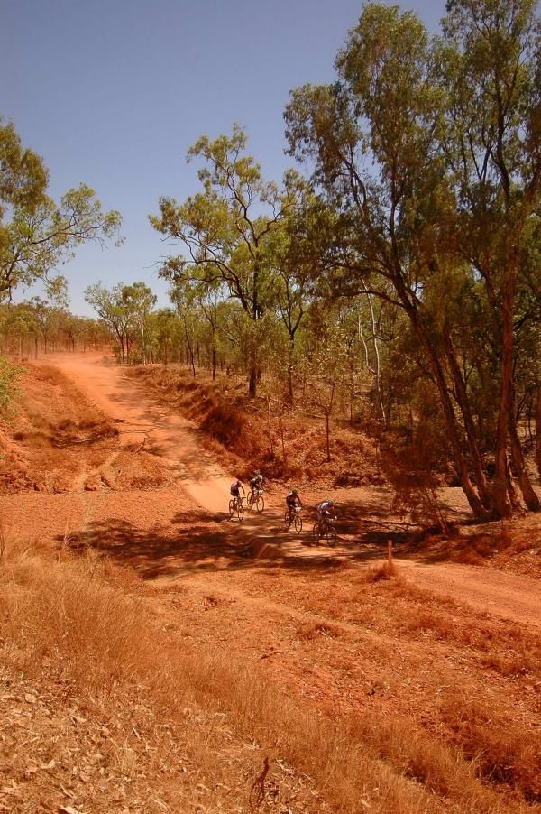 The lead group passes over an outback creek.