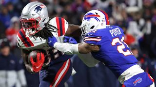 Rhamondre Stevenson #38 of the New England Patriots carries the ball as Jordan Poyer #21 of the Buffalo Bills tackles in the third quarter of the game at Highmark Stadium on December 6, 2021 in Orchard Park, New York.