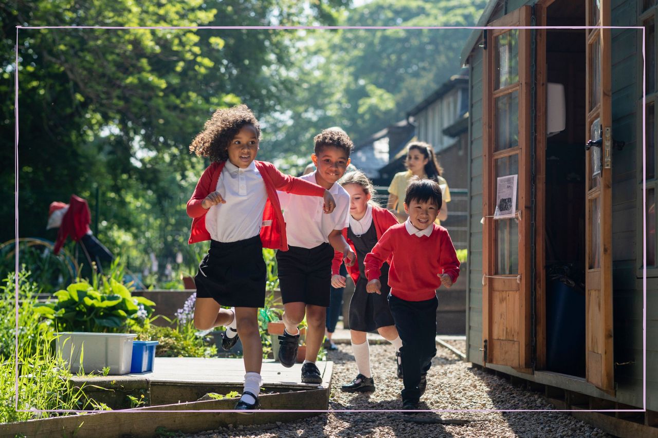 A group of young children running from their classroom