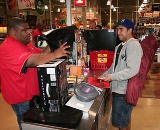 Rollin Asumbrado (right) pays for his PS3.