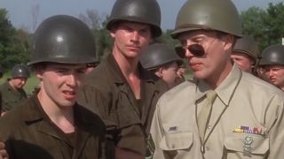 Christopher Walken looking over his sunglass at Matthew Broderick in a military uniform