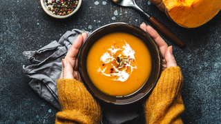 Woman cradling bowl of soup