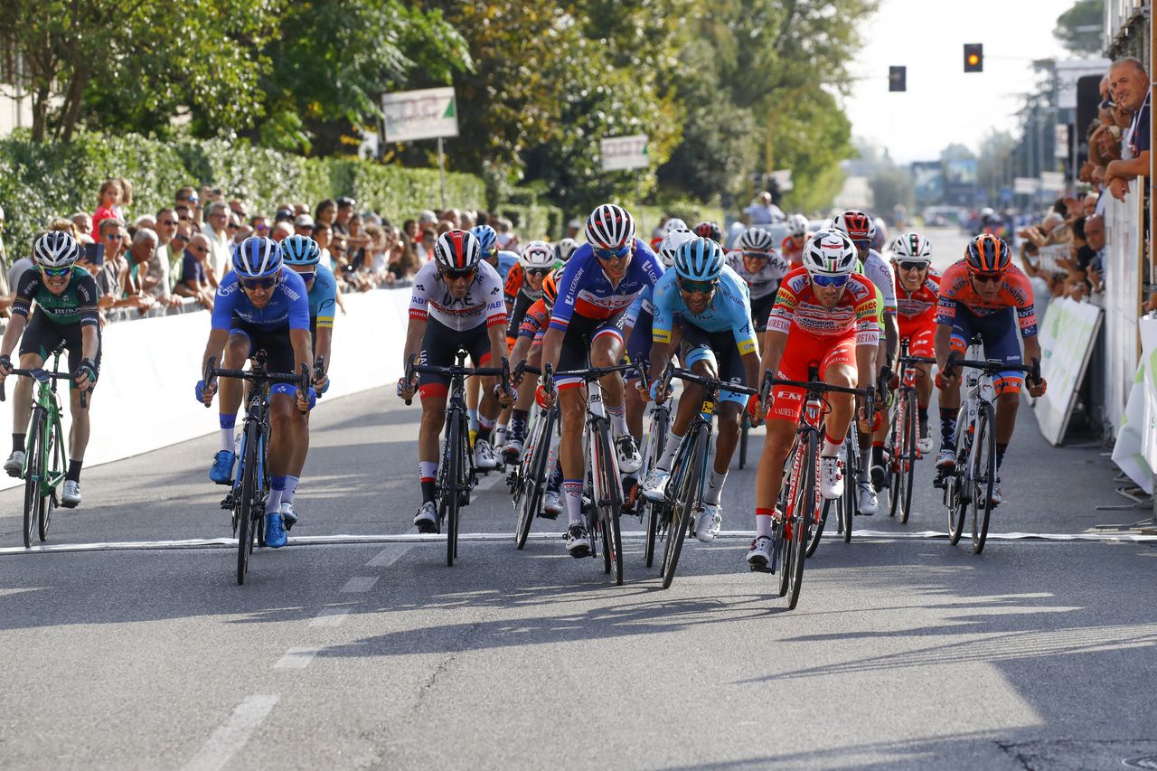 The peloton trails in after the attackers