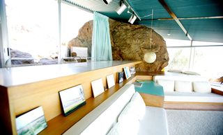 Interior living area with large boulder as main feature of room
