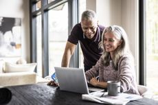 Senior couple using laptop at home