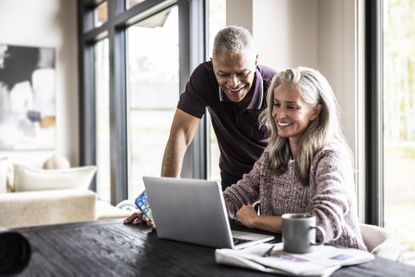 Senior couple using laptop at home
