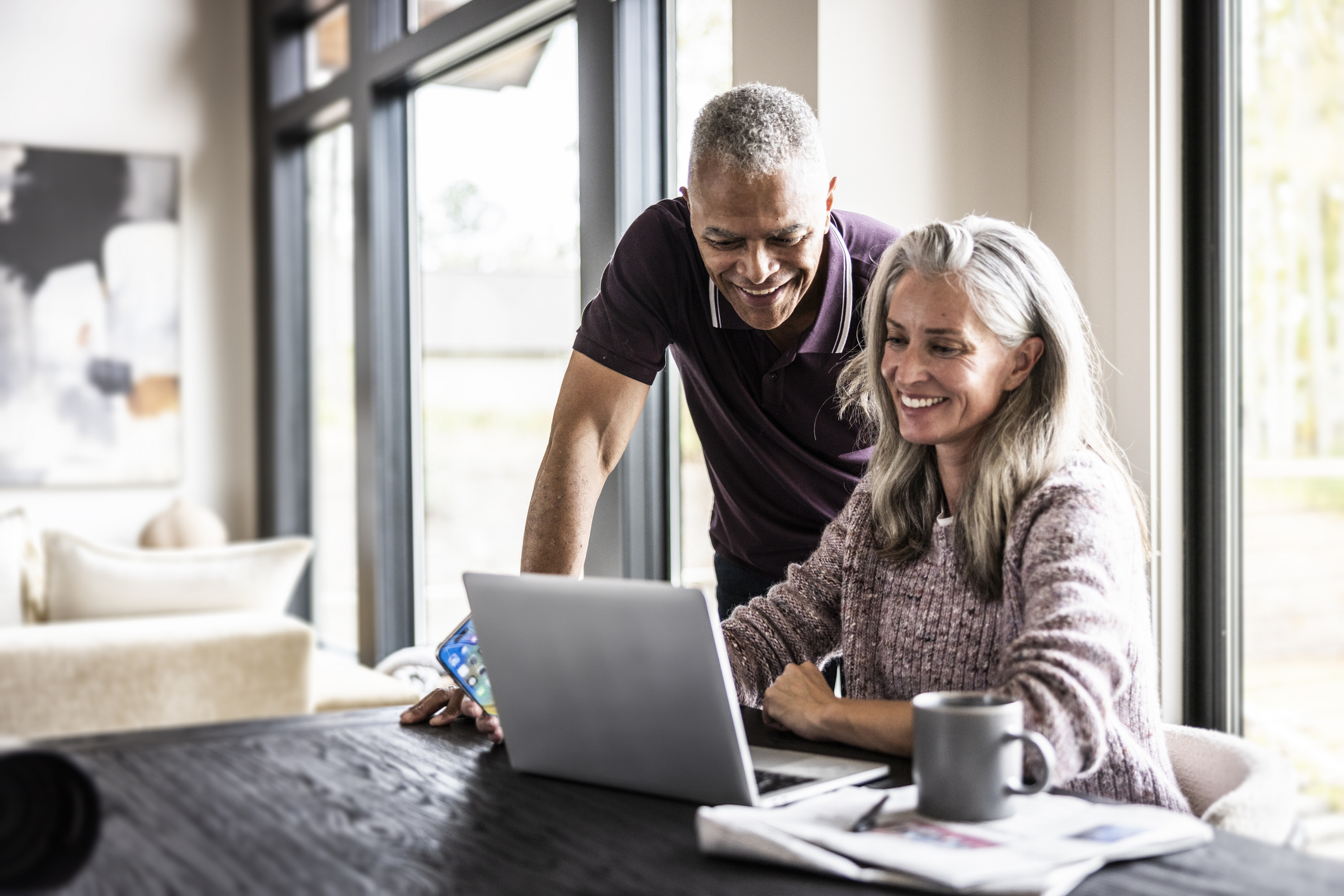 Senior couple using laptop at home