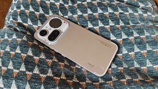 Photos of a silver phone on a cushion