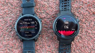 A photo of the Garmin Fenix 8 and COROS PACE Pro sitting on track turf, showing heart rate averages and maxes for a track workout.