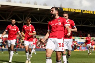 Elliott Lee of Wrexham celebrates scoring his team's first goal during the Sky Bet League Two match between Wrexham and Forest Green Rovers at Racecourse Ground on April 13, 2024 in Wrexham, Wales. (Photo by Charlotte Tattersall/Getty Images) (Photo by Charlotte Tattersall/Getty Images)