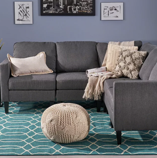 grey sectional sofa with a green rug