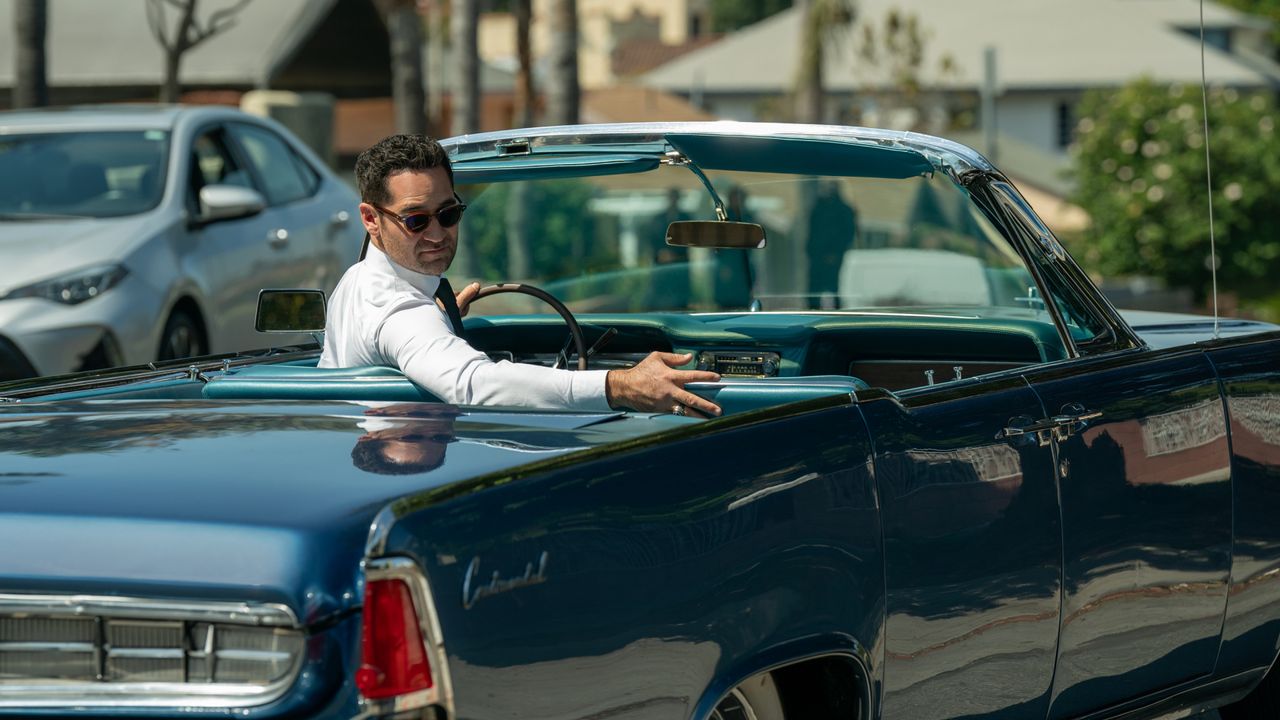 Manuel Garcia-Rulfo as Mickey Haller, looking back from the driver&#039;s seat of a convertible Lincoln, in episode 303 of The Lincoln Lawyer.