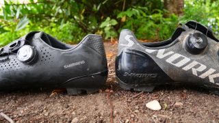 Shimano RX8 and Specialized S-Works Recon heel to heel on a dirt surface
