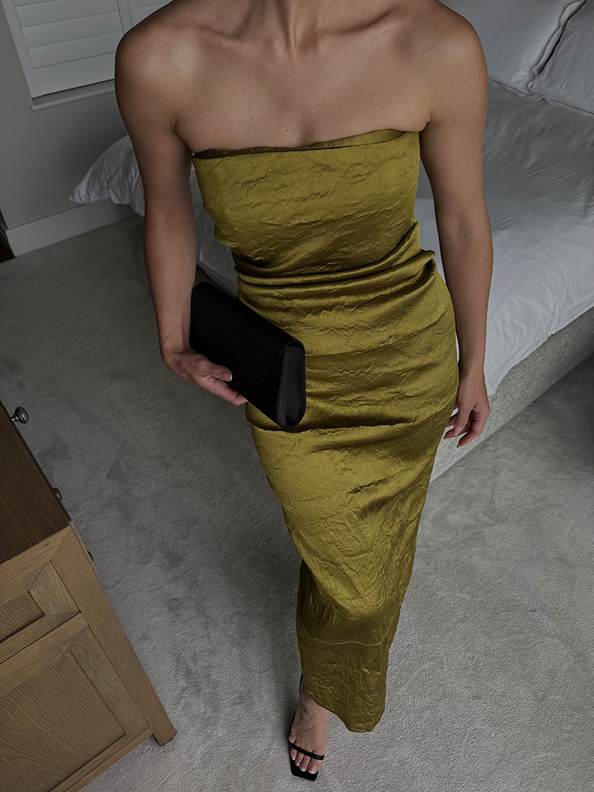 Bettina Looney wearing a green strapless Tove dress.