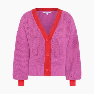 A cutout of a red and pink cardigan by Omnes on an off-white background