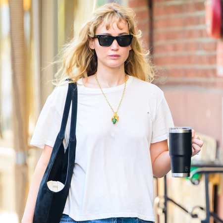 Jennifer Lawrence wearing bootcut jeans with a white T-shirt and ballet flats