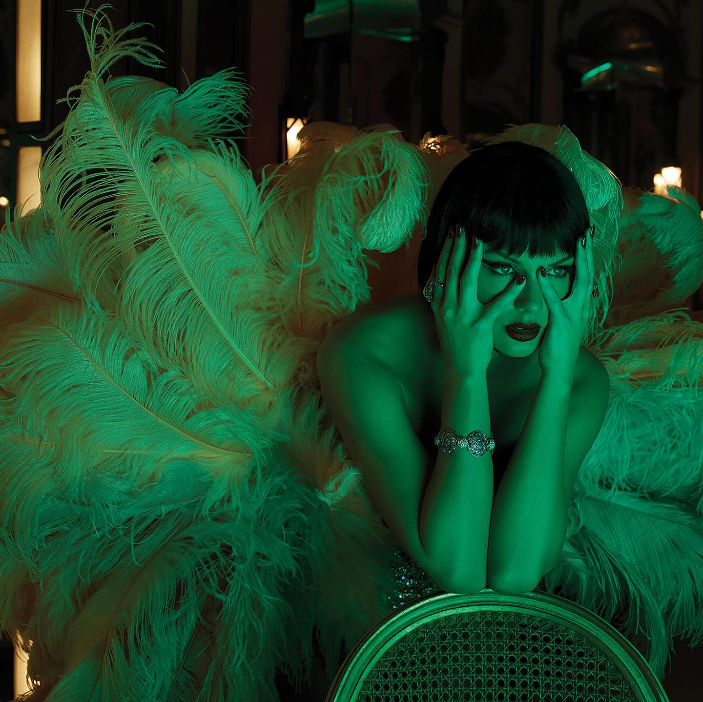 Taylor Swift on the set of her Life of a Showgirl photoshoot wearing a wig and feathers