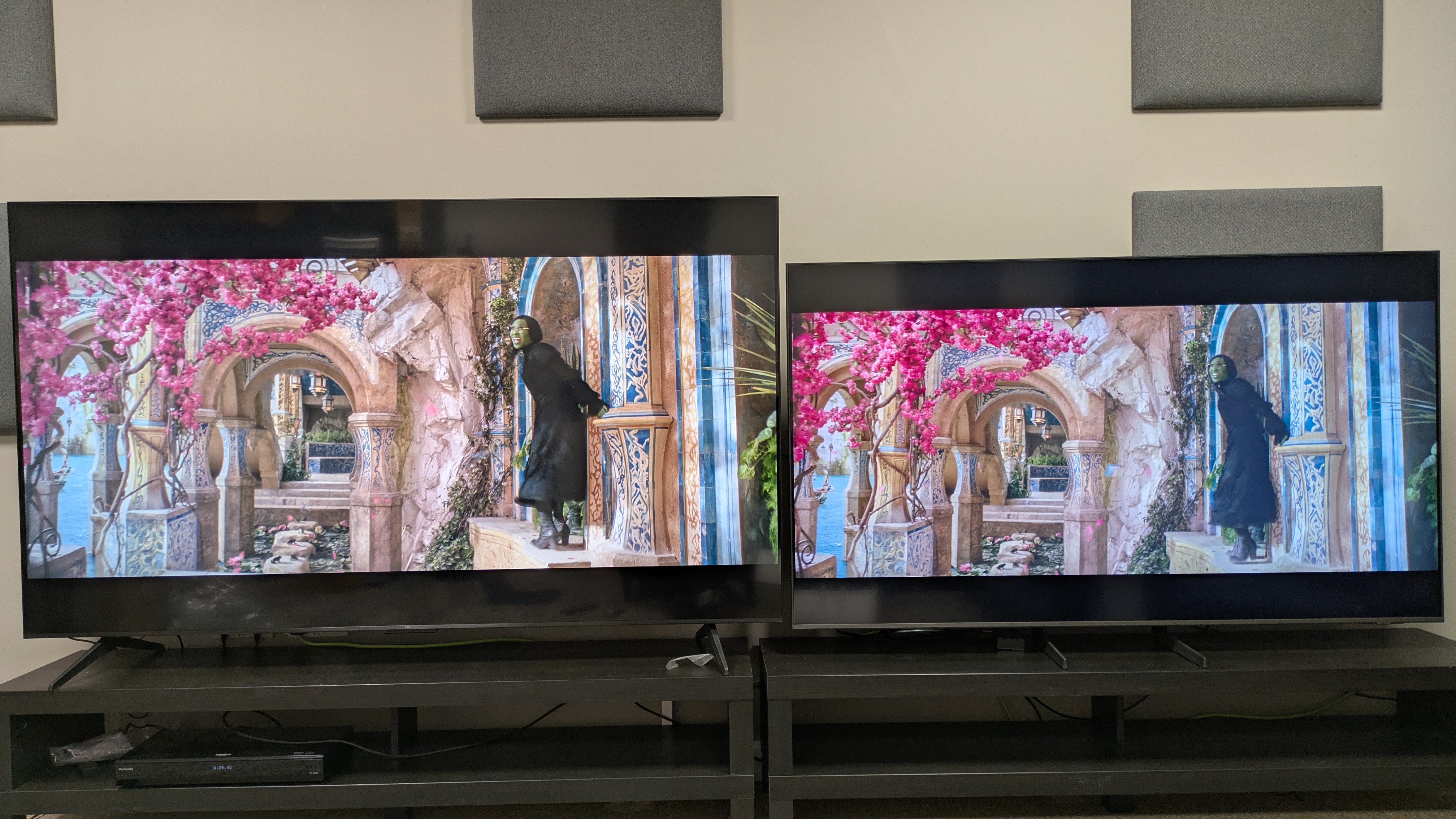 TCL Q6C (left) vs Samsung Q8F (right) showing Elphaba from Wicked on screen, with color booster activated on the Samsung Q8F