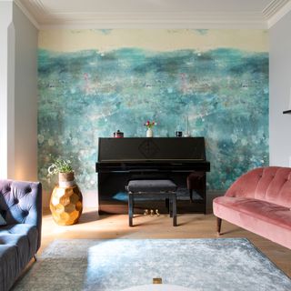 Living room with wallpaper feature wall and two sofas on either side of piano