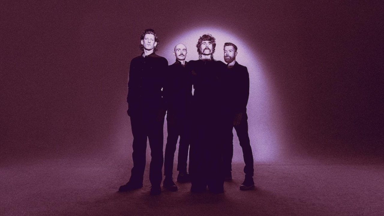 AFI looking solemn against a spotlit purple background