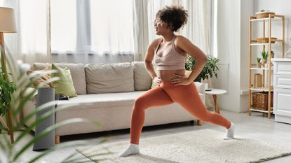 Woman practicing yoga in a sunlit living room