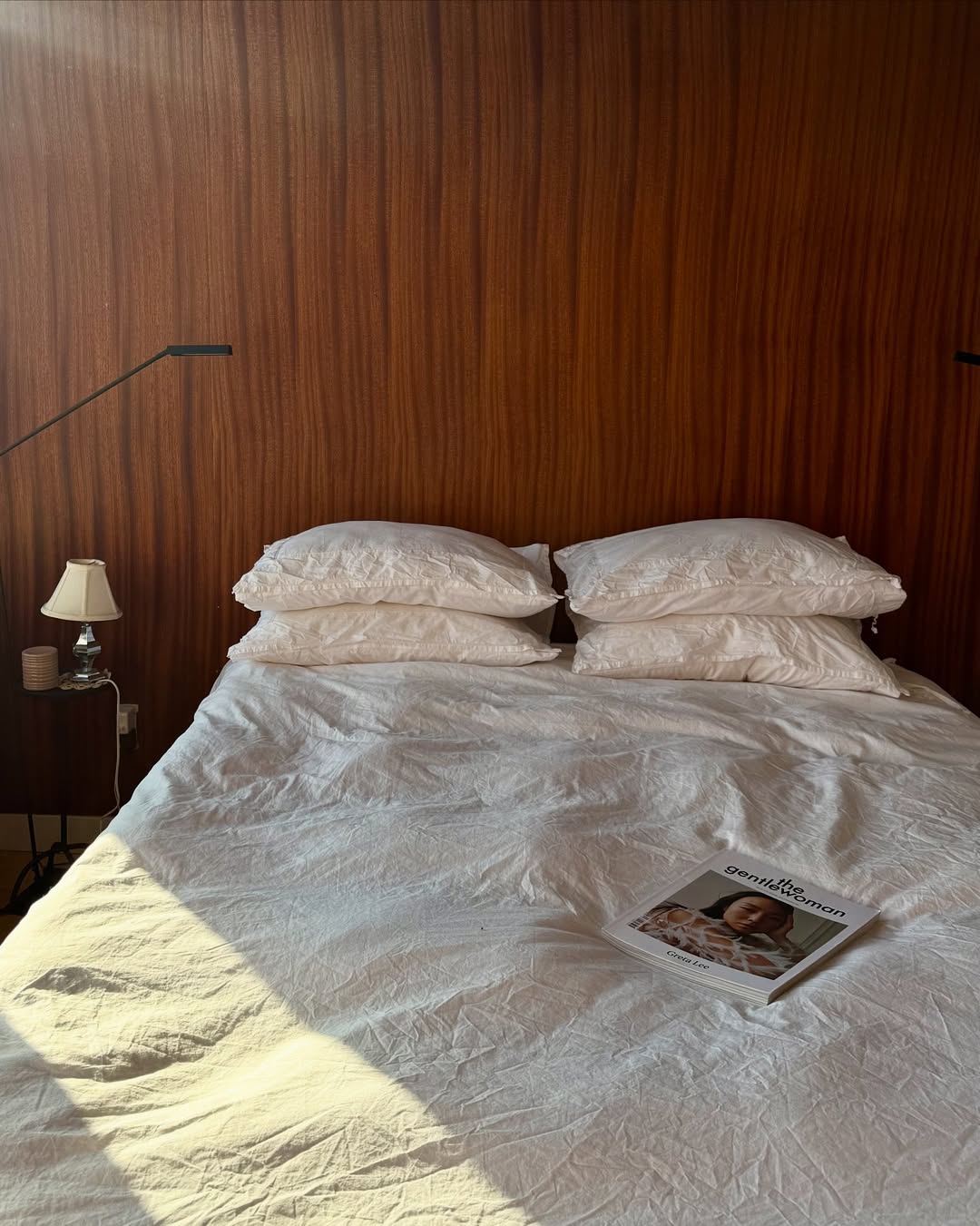 Room with walnut accent wall and linen bedding