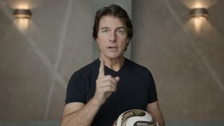 Tom Cruise holding soccer ball and holding #1 finger up in ad for Digger and World Cup
