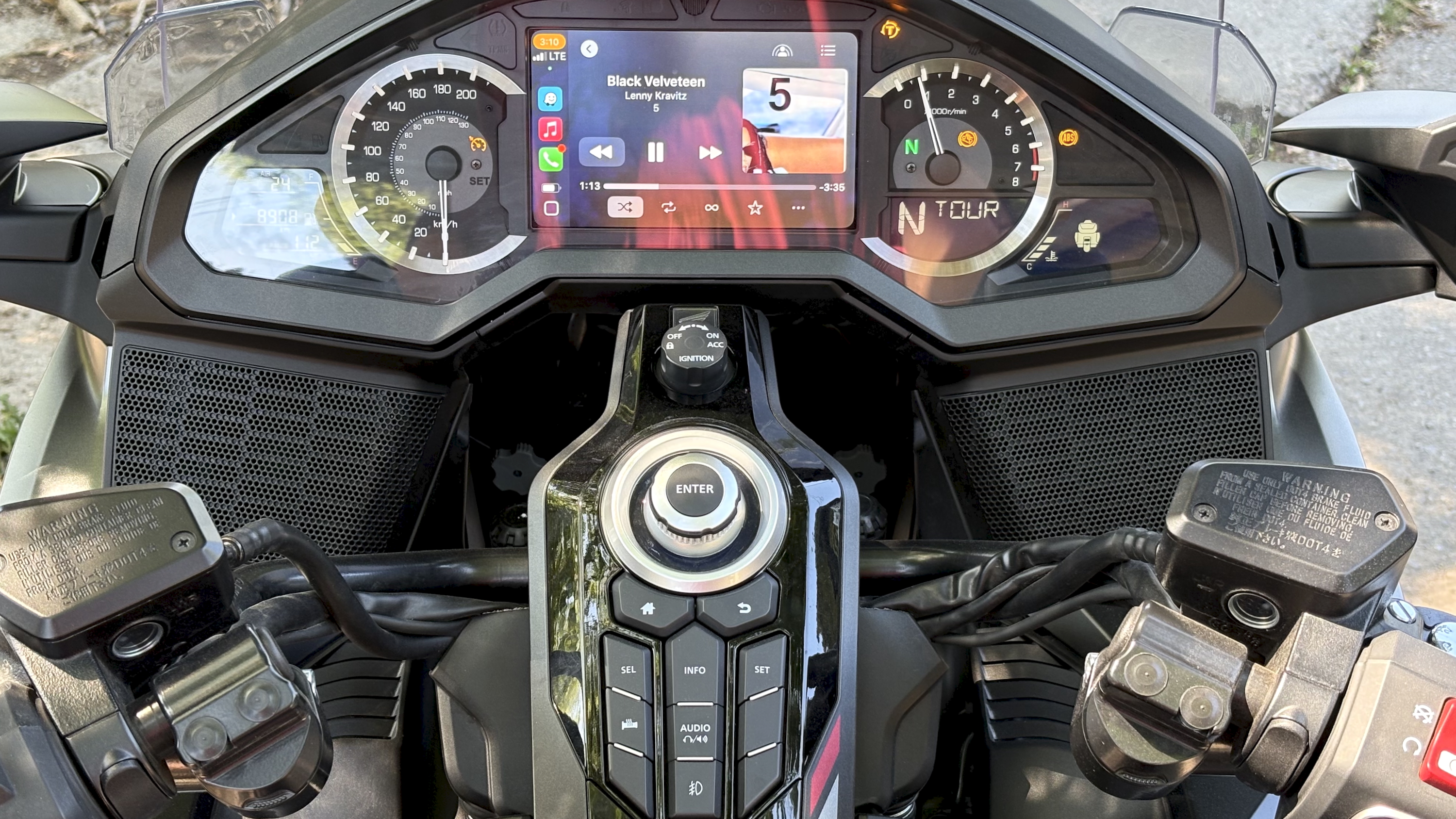 A Honda Goldwing touring motorbike, emphasising the sound system onboard, with a driver in a bike helmet