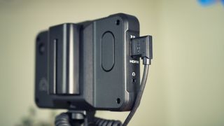 Close up of the HDMI port on an Atomos Shinobi on-camera monitor mounted on a Panasonic mirrorless camera