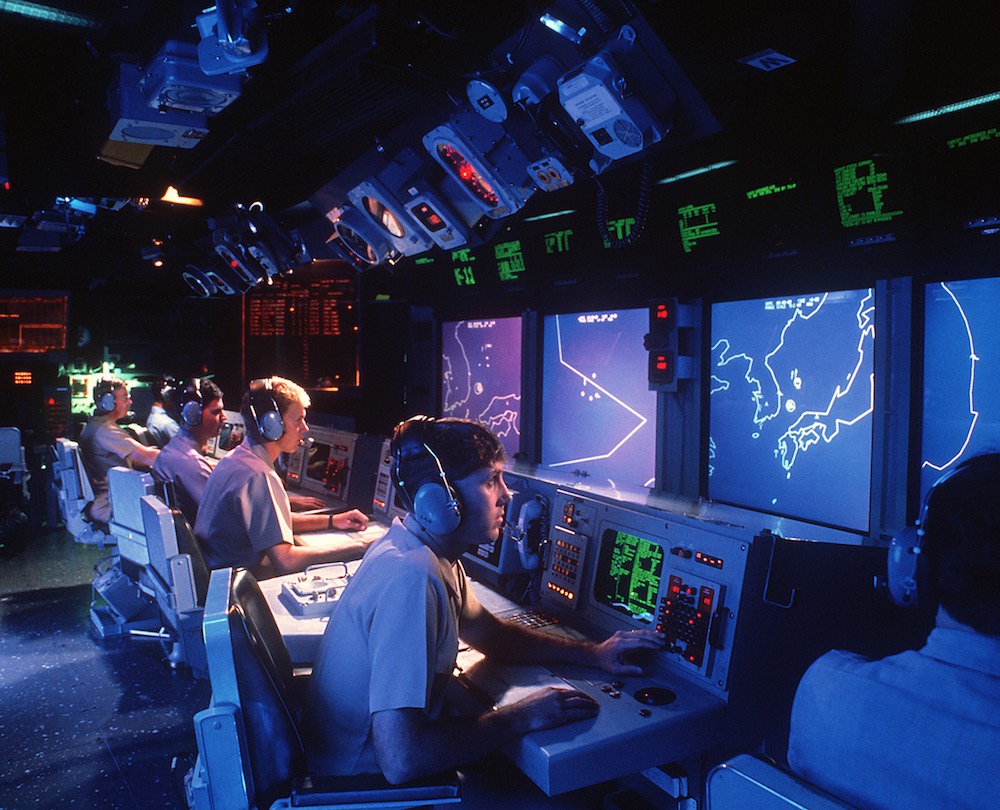 Crew members monitor radar screens in the combat information center aboard the guided missile cruiser USS Vincennes in 1988.